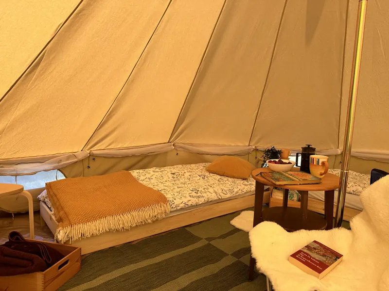Bed inside a glamping tent
