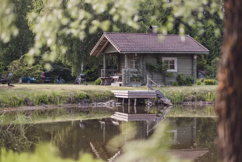 Log sauna on the edge of the pond